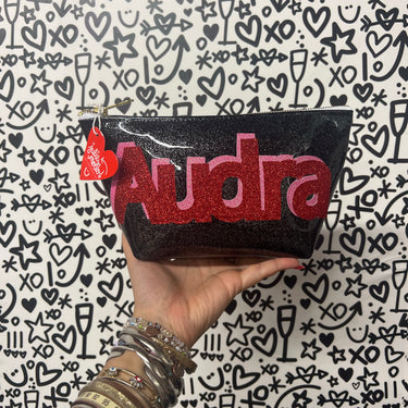 Cute and custom black glitter infused vinyl pouch with a pink adn red glitter "Audra" applique sewn on the front.