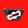 blood drop confetti sealed with clear vinyl on a white glitter canvas pad appliqué on a black glitter-infused vinyl pouch.