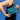 Person wearing Shoulder bag with blue Magic Wand doodle appliqués from Julie's custom MW doodle print sewn onto black sparkle glitter vinyl and coated with a clear vinyl. Shoulder strap is a clear acrylic chain.