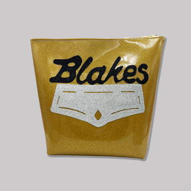 glittery gold vinyl with a silver applique and glittery black text that reads "Blakes".