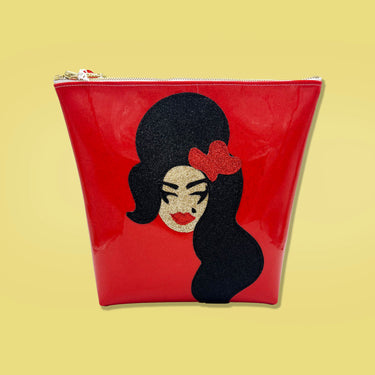 Glitter canvas portrait of Amy Winehouse on a bright red vinyl bag. 