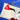 A close-up of a white clutch with black eyeliner and red lip appliques. On the top of a bag is a cute gold XOXO zipper pull that is signature to Julie Mollo!. Connected to the zipper is a clear acrylic chain wrist strap. Red heart Julie Mollo! tag is connected to zipper.