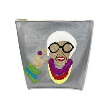 Colorful glitter canvas portrait of Iris Apfel on a glitter infused silver vinyl bag. Bag has a Julie Mollo custom XOXO zipper pull on the top.