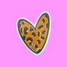 heart-shaped sticker with rich, golden-brown hues and iconic black spots of a leopard print. 