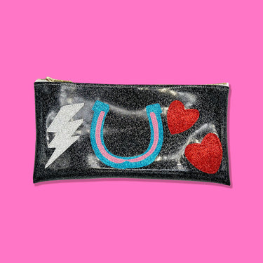 Black vinyl clutch with colorful appliques of some of Amy Winehouse's iconic tattoos. 