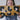 Woman holding a cute clutch with black and gold spots sewn onto gold glitter vinyl. Clutch is adorned on top with a Julie Mollo custom XOXO zipper.
