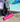 Woman wearing athleisure outfit using yoga mat carrying strap that features Julie Mollo signature doodle print.