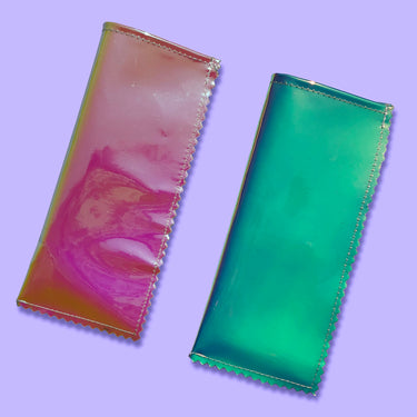 Two iridescent sunglasses sleeves. One sleeve is a pinky orange color and the other is a blueish green color. 
